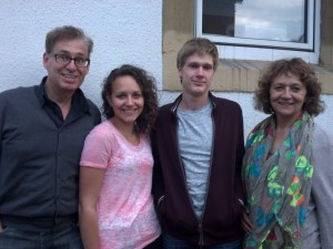 Adam and his host family in front of their house